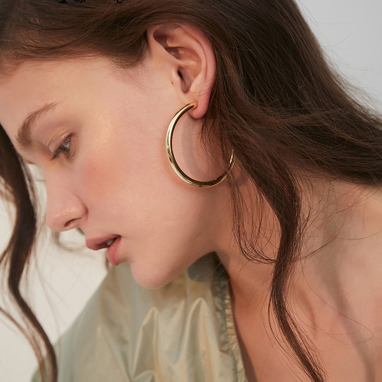 Model wearing gold earrings